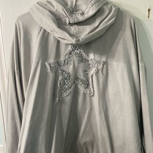 open cardigan style hoodie. sparkly star feature. Drawstring detail on bottom.